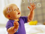 Lovely baby playing with bubles