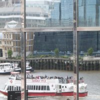 London building reflection of sightseeing boat and other building