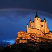 rainbow over castle on a cliff