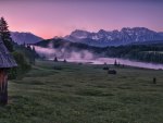 cabins on the meadow with fog off the lake
