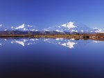 The beauty reflection of the mountain in the blue lake 