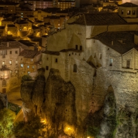 fantastic castle in a cliff above a city