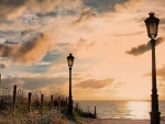 lamp posts on a beautiful beach at sunset