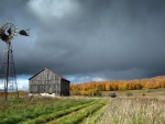 well windmill on a farm awaiting a storm