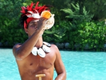 Tahitian Man blowing Conch Shell at Bora Bora Paradise Island Tahiti