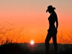 Cowgirl in the sunset