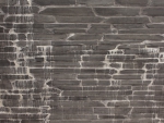 Black small tile wall with streaks