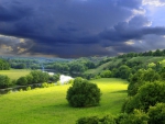 storm clouds over a river valley