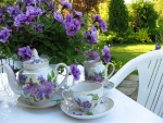 Garden table with flowers and tea