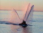 Fireboat spraying at sunrise