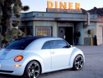 new vw beetle ragster in front of a diner