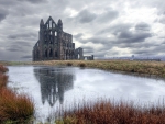 whitby abbey ruins by a pond hdr
