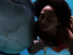Beauty swimming with a dolphin