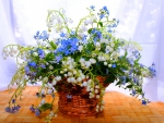 Basket with flowers lily of the valley and forget-me-not