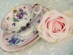 Cup tea with pink rose