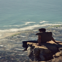 Awesome Picture of a Man Sitting on a Cliff Ledge in Cape Town