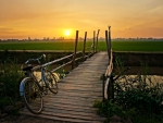 Bicycle forgotten on the bridge at sunset