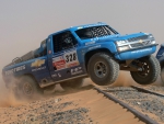 CHEVROLET SILVERADO PICK UP FLYING OVER THE LINES OF THE TRAIN