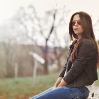 Beautiful Woman in Jacket Wearing Sunglasses