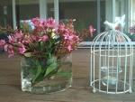 *vase with flowers and  cage with candle*