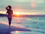 girl walking on a beach at sunset