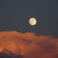 full moon above the storm clouds