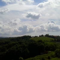 Clouds over forest hill