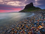 castle ruins on colored stones beach