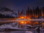 House by the lake in winter night