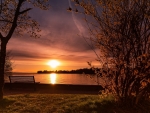 The Bench at the Lake Shore at Sunset