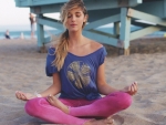 Lauren York meditating at the beach