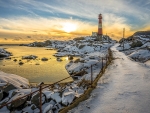 Lighthouse in the Snow at Sunset