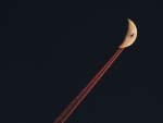 Plane Crossing a Crescent Moon