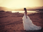 Brunette bride at sunset on the beach