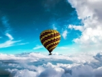 Hot air balloon above clouds