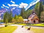 Church and Braies lake in Dolomites, Italy