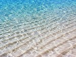 Translucent Sea Water Shimmer over White Sand