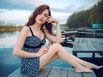 Brunette sitting on boat dock