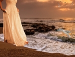 Serenity by the Shore: Woman in White Dress Amidst Seagulls
