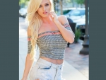 Sexy blonde model in cut off jean shorts