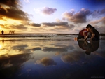 Boy Playing on the Beach at Dusk