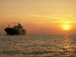 Container Ship sailing off the sunset
