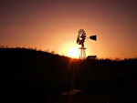 Sun setting behind windmill