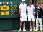 John Isner, Nicolas Mahut & Umpire standing next to the historic scoreboard after the longest match in Open history.